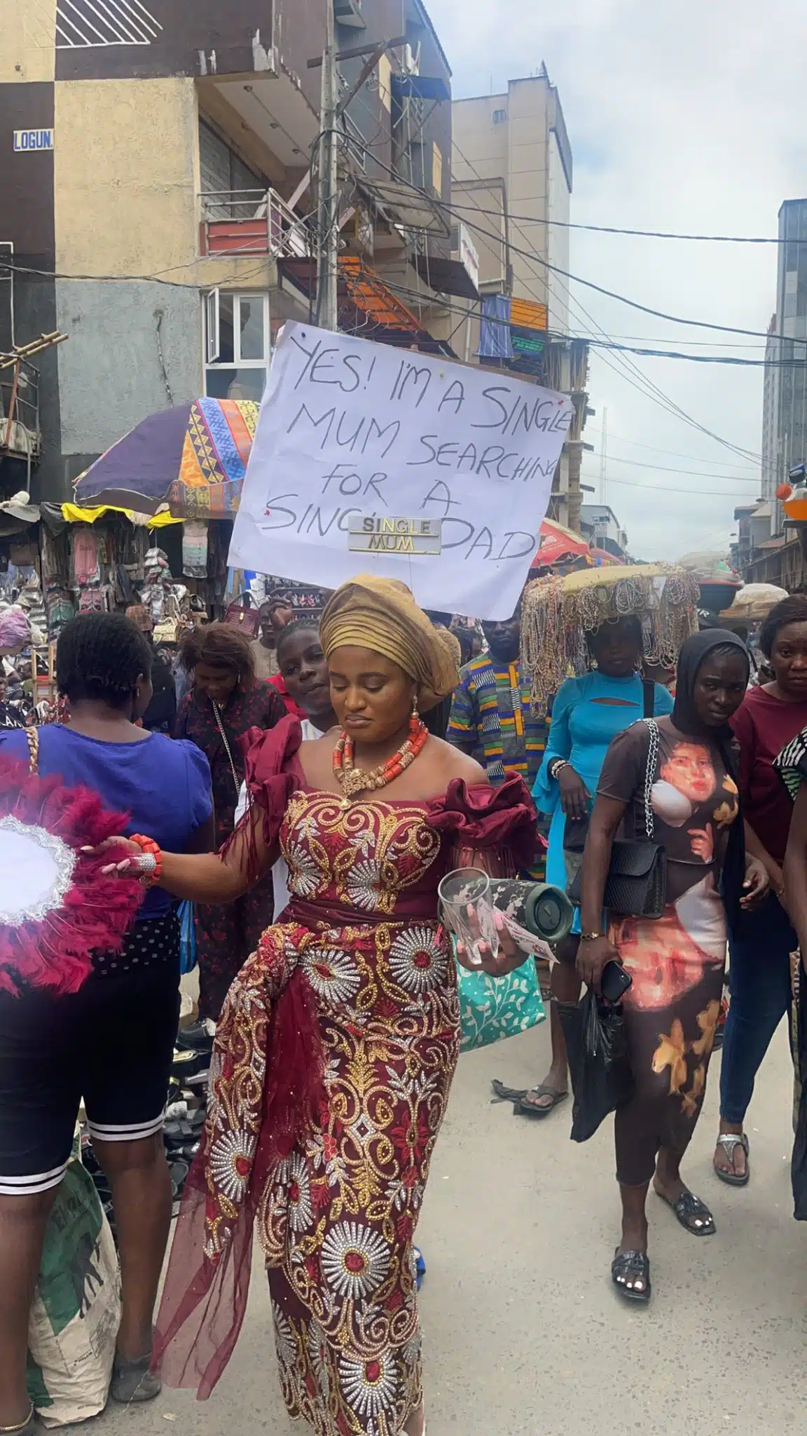 VIDEO: Single Mother Storms Lagos Market With Placard In Search Of A Single Father – TheNGblog