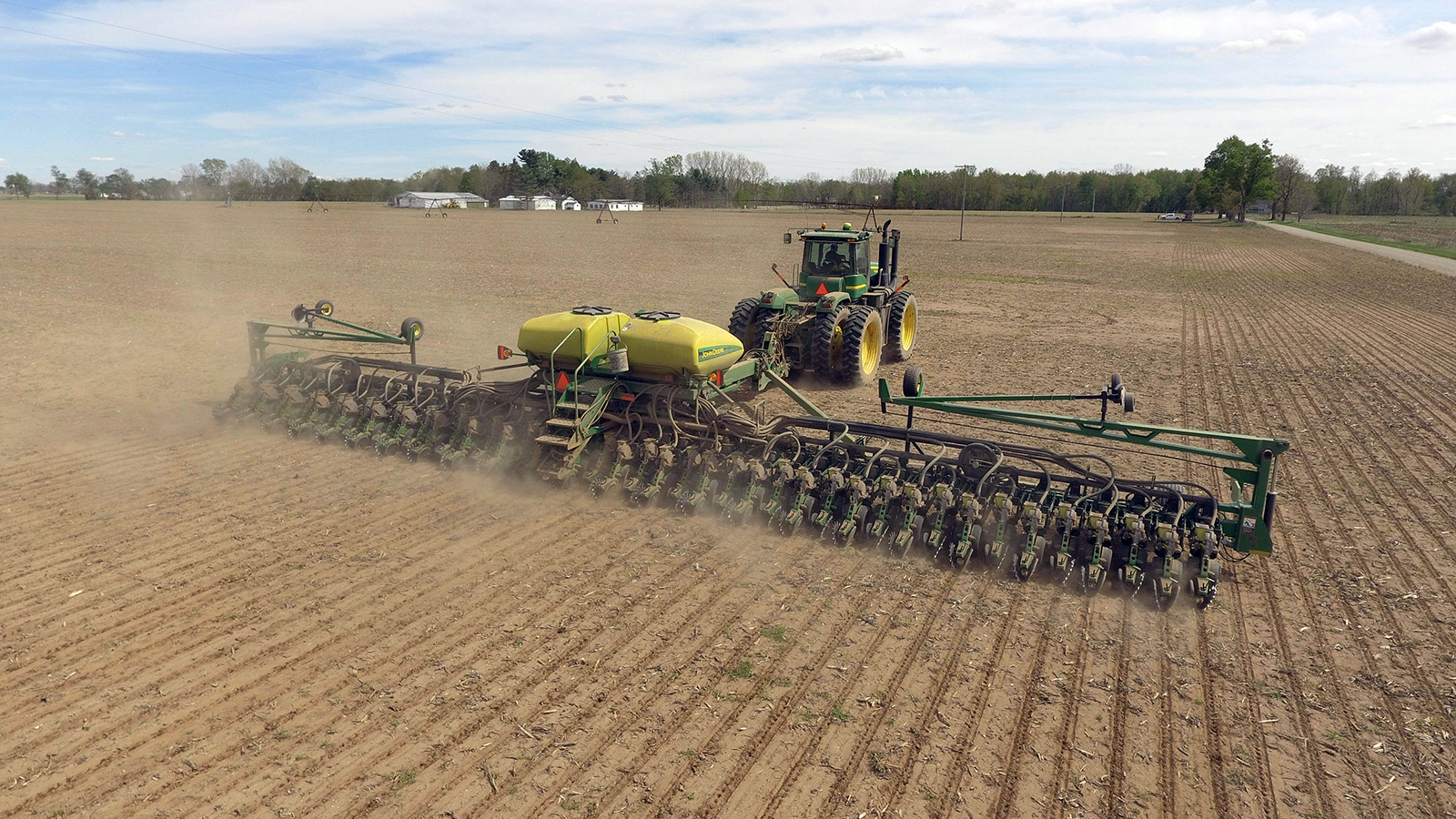 A tractor pulls a planter in Michigan. (Photo by Loren King/Unsplash/Creative Commons)