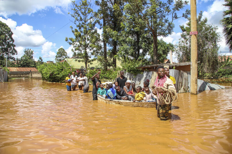 A family uses a boat after fleeing floodwaters that wreaked havoc in the Githurai area of Nairobi, Kenya, April 24, 2024. Extreme weather events have hit parts of Africa relentlessly in the last three years, with tropical storms, floods and drought causing crises of hunger and displacement. (AP Photo/Patrick Ngugi, File)