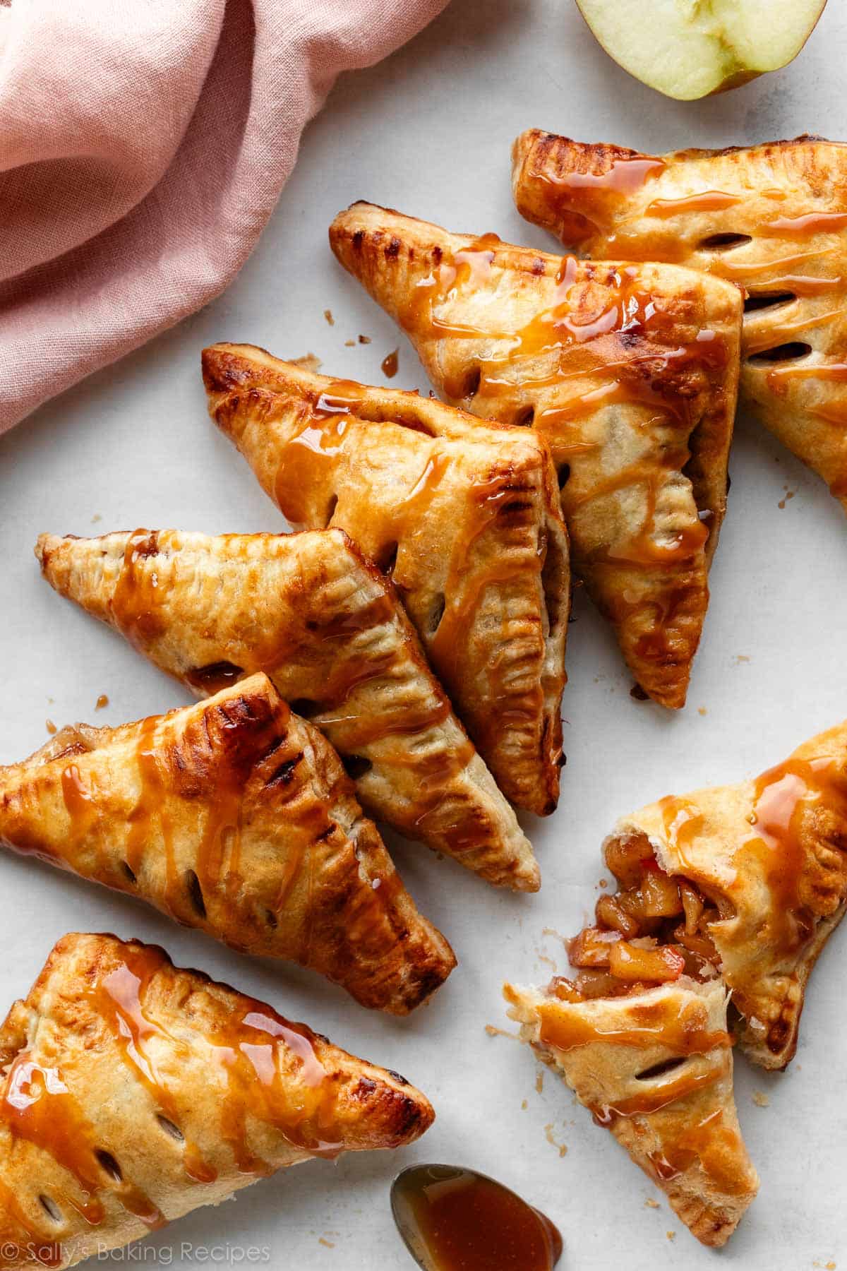 apple turnovers with caramel sauce on top in a diagonal line.