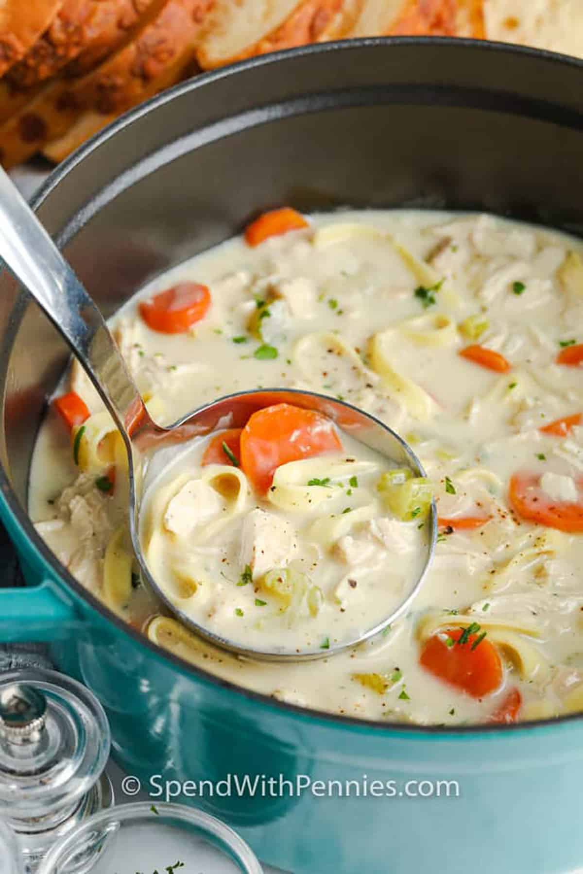 Creamy Chicken Noodle Soup in the pot with a ladle