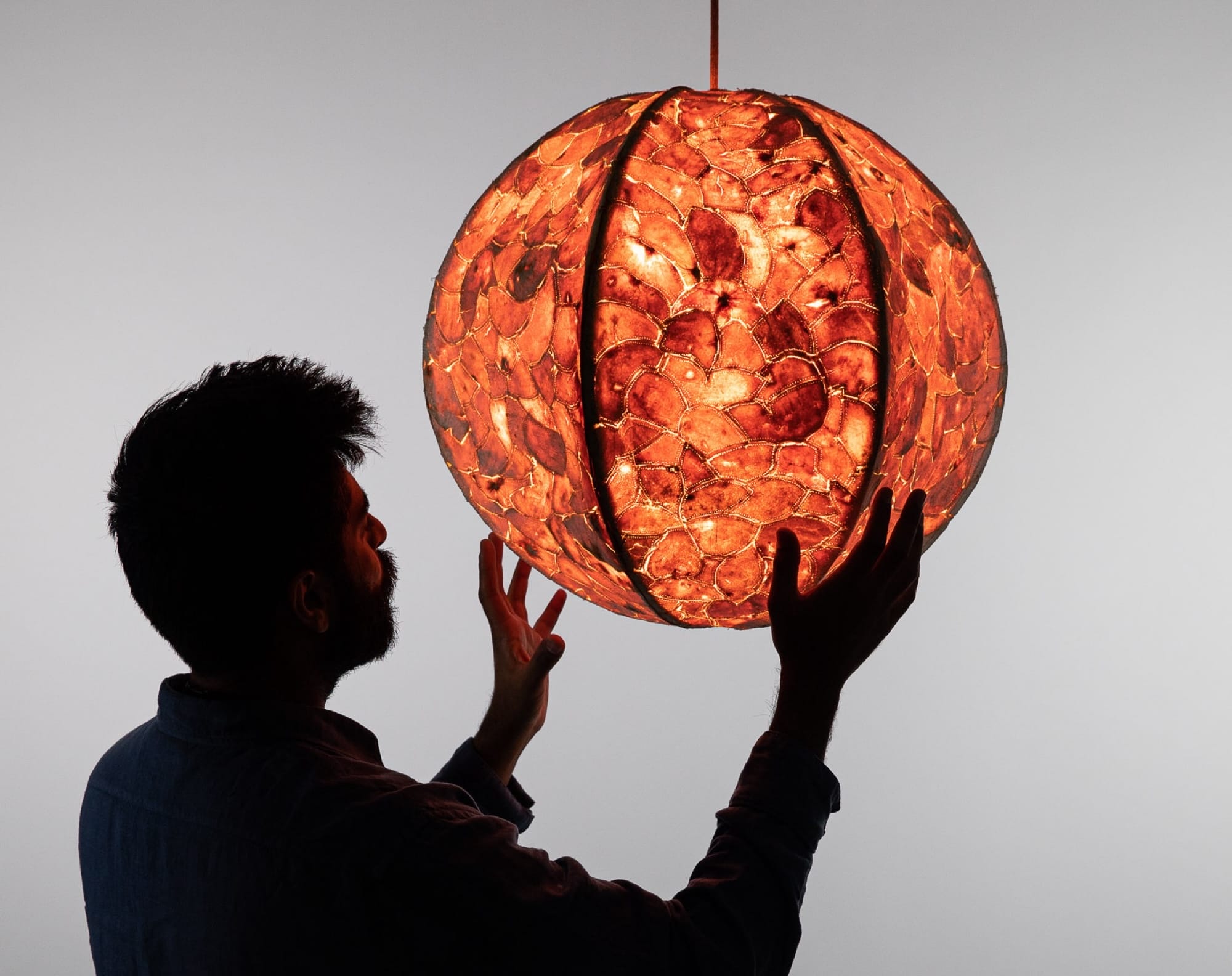 A Patchwork of Orange Peels Envelops a Contemporary Pendant Lamp — Colossal